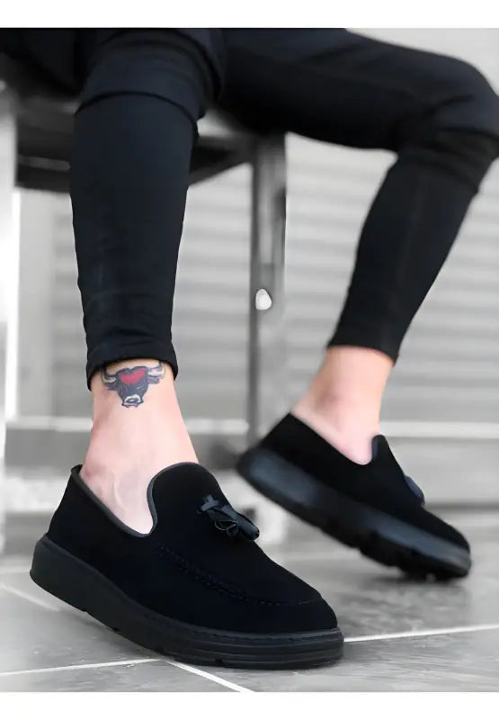 Black suede slip-on shoes with thick rubber soles.