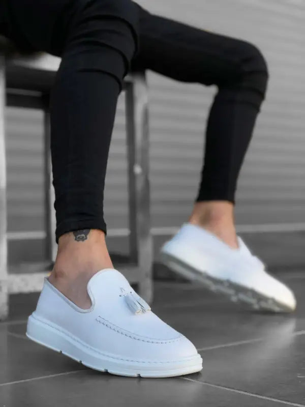 Clean white slip-on sneakers with a minimalist design.
