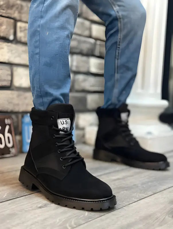 Black suede combat boots with thick rubber soles and laces.