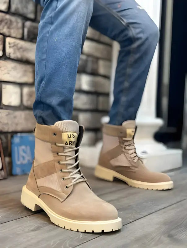 Tan military-style combat boots with ’US ARMY’ branding and cream-colored soles.