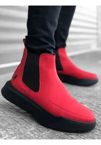 Bright red Chelsea boots with black elastic sides and chunky black soles.