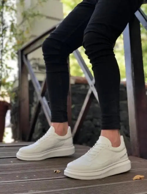 White platform sneakers with a chunky sole and minimalist design.