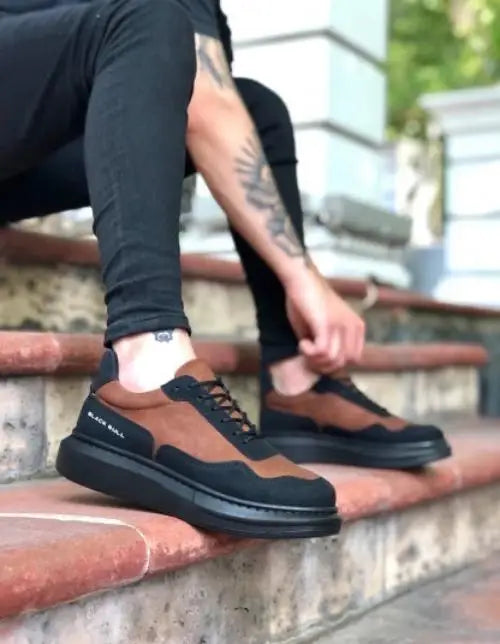 Brown and black casual sneakers with a thick platform sole and laces.