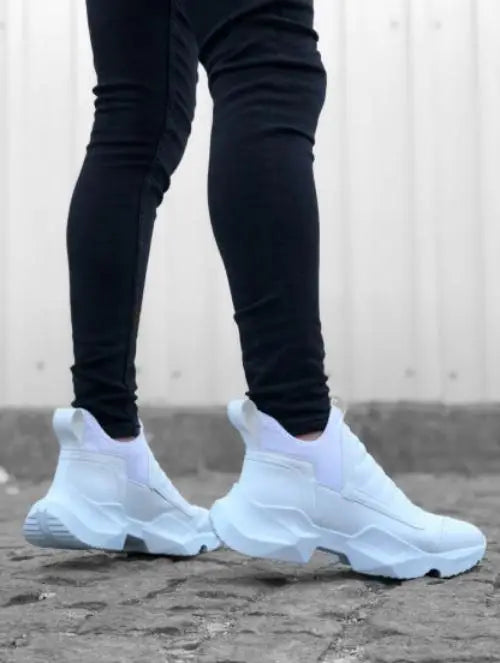 White chunky slip-on sneakers with a sock-like upper design.