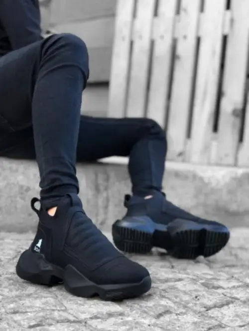 Black sock-style athletic sneakers with chunky soles.