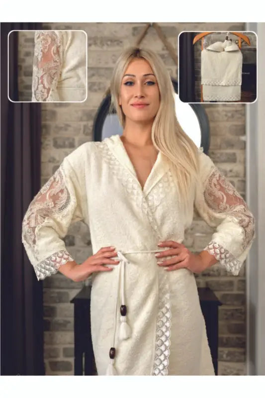 Elegant cream-colored embroidered robe with decorative floral sleeve details and button closures.