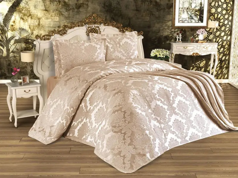 Elegant beige jacquard bedding set with damask pattern on a decorative bed frame.