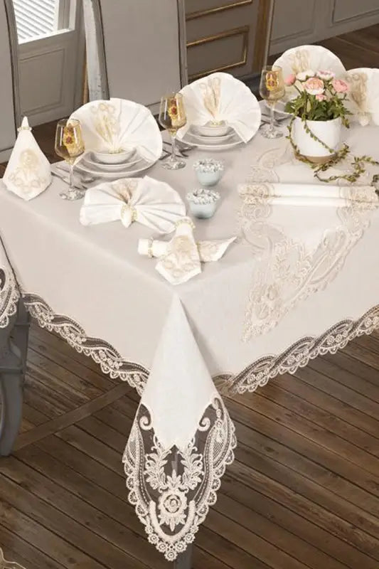 Elegant white lace-trimmed tablecloth with ornate damask patterns.