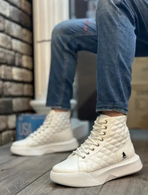 White high-top canvas sneakers with thick soles and laces.