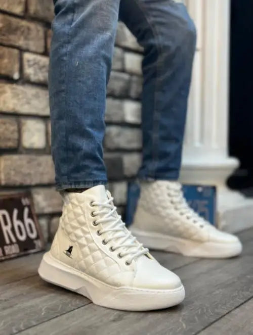 White quilted high-top sneakers with a padded texture and lace-up design.