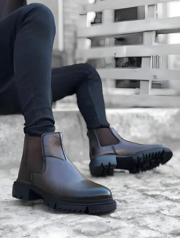 Brown leather Chelsea boots with chunky black soles.