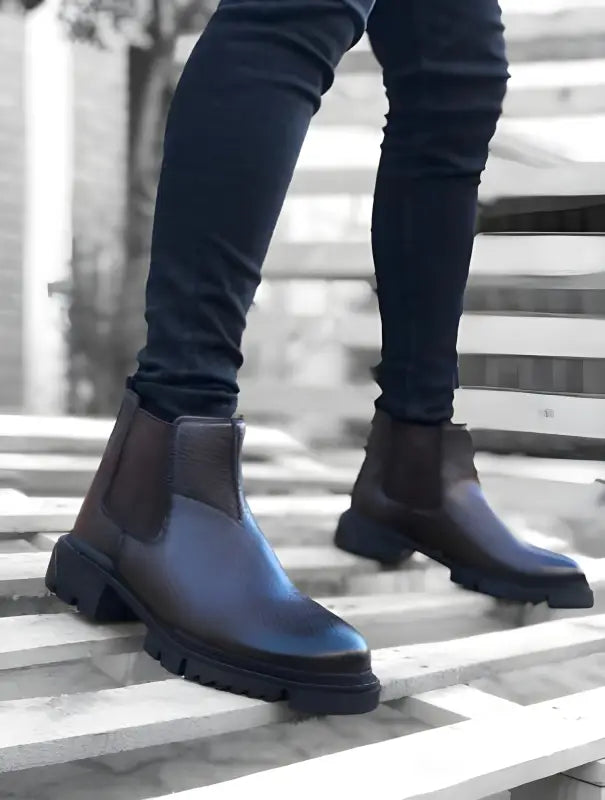 Dark brown Chelsea boots with chunky rubber soles.