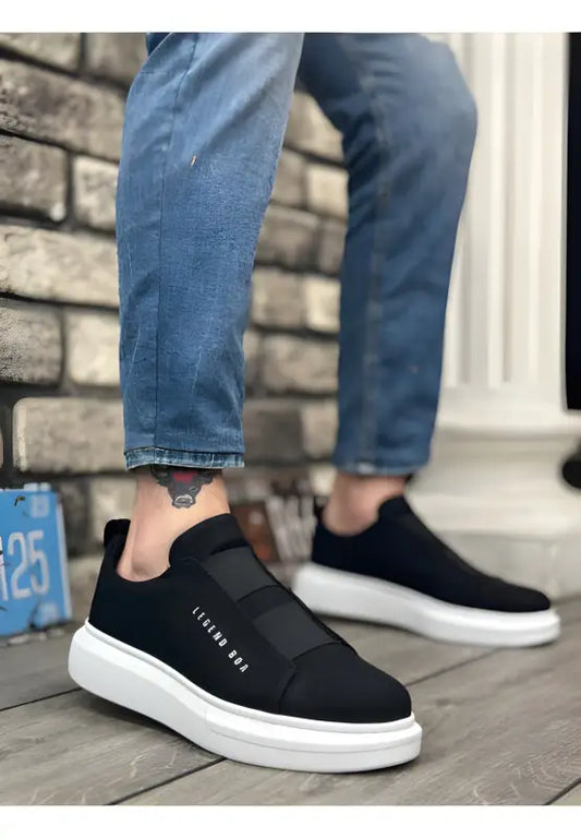 Black slip-on sneakers with white soles and elastic panels.