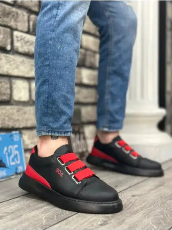 Black sneakers with bright red straps and a black sole.