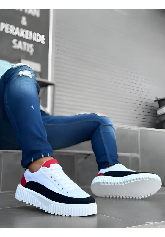 White, black and red sneakers with a chunky platform sole.