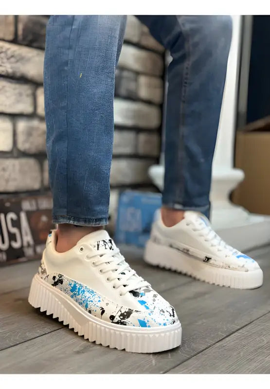 White platform sneakers with blue Mickey Mouse pattern details.