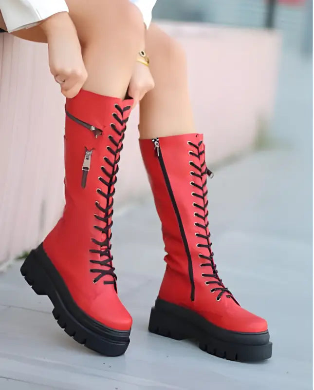 Red lace-up platform combat boots with side zippers.