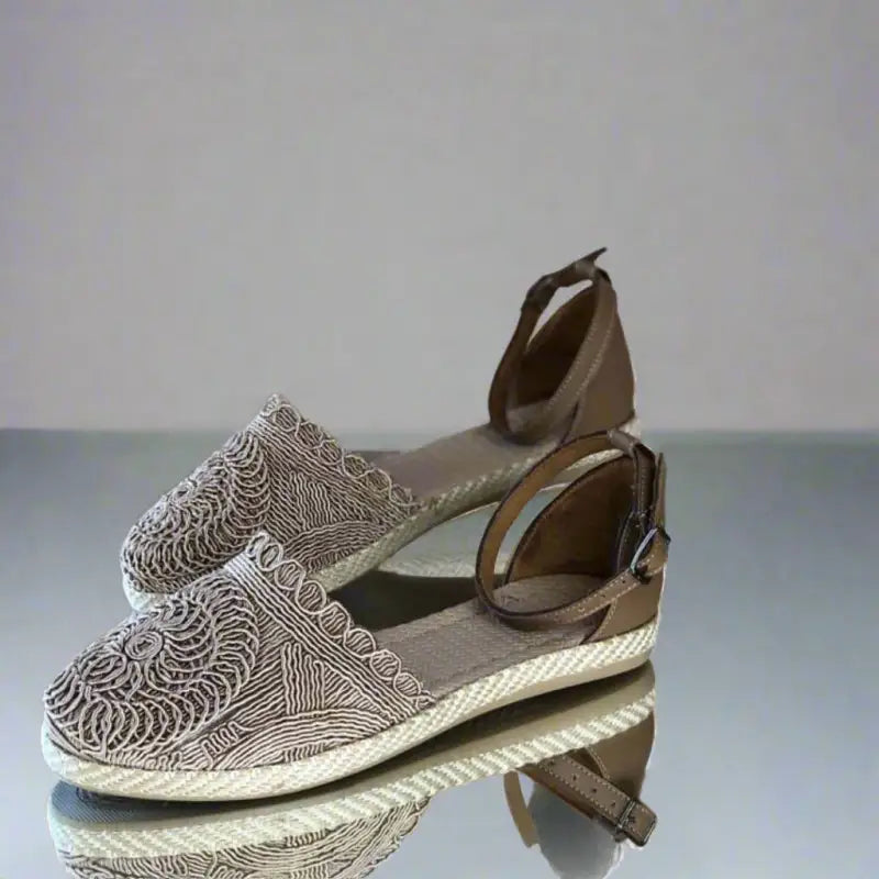 Patterned espadrille sandal with ankle strap and rope-trimmed sole.