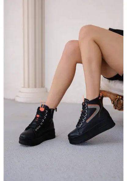 Black platform high-top sneakers with orange accents and chunky soles.