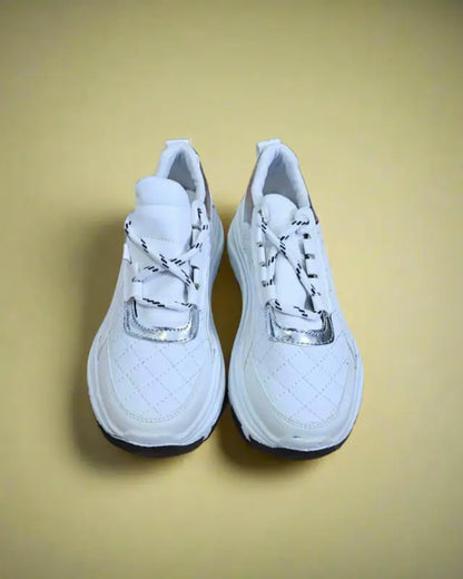 Pair of white athletic running shoes with laces.