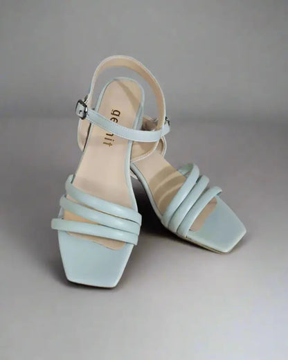 Mint green strappy sandals with a square toe and low heel.