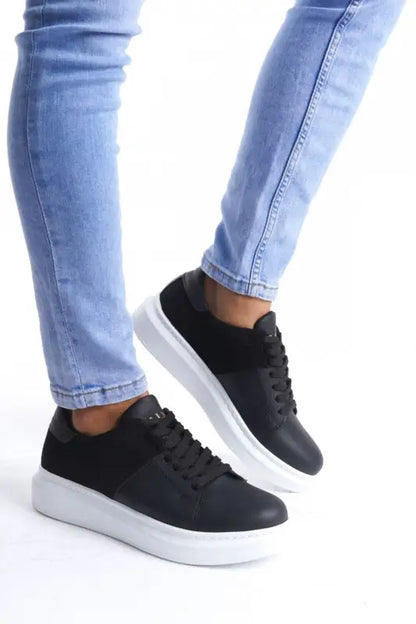 Black leather sneakers with white platform soles and laces.