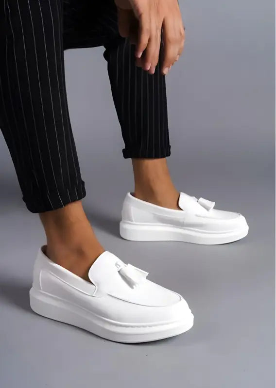 White platform loafers with decorative bow detail.