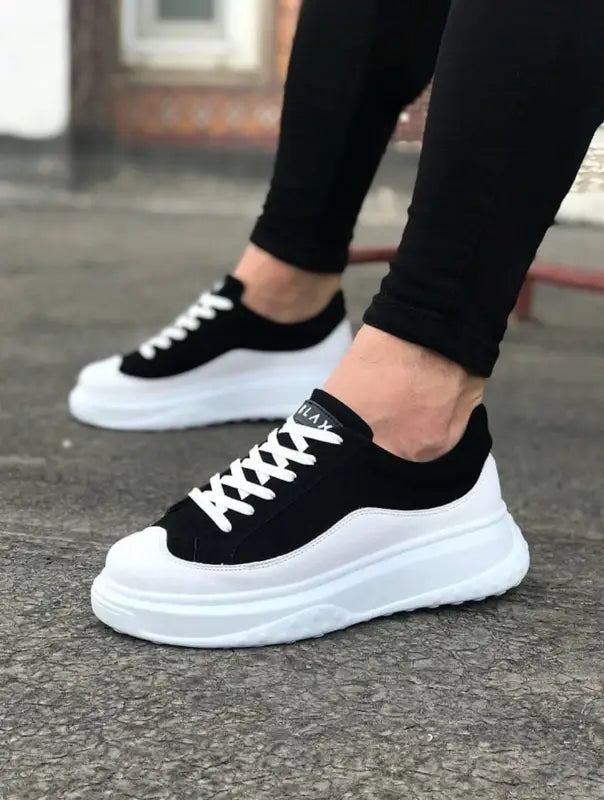 Black and white platform sneakers with thick white soles and black laces.