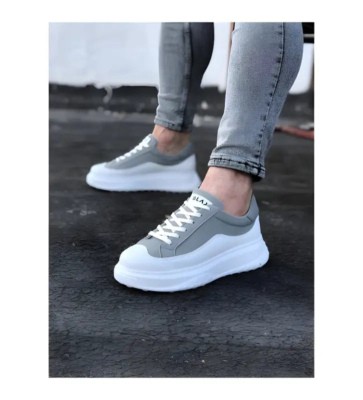 Gray and white platform sneakers with chunky soles and laces.