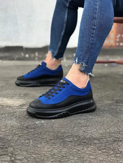 Blue and black chunky sneaker with a thick platform sole and distressed denim above it.