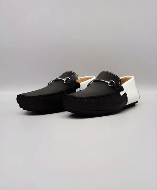 Black and white leather driving loafers with metal horsebit detail.