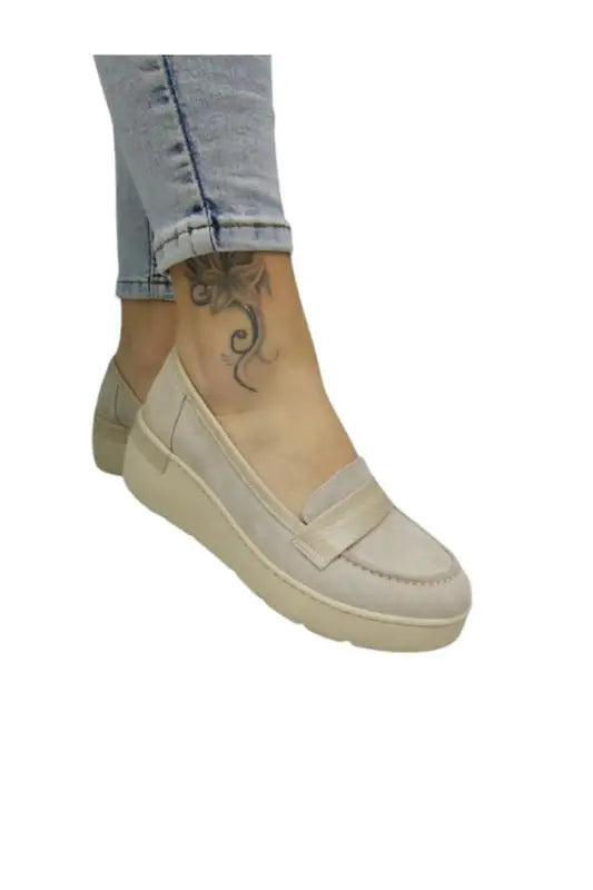 Beige platform loafer with a thick sole and slip-on design.