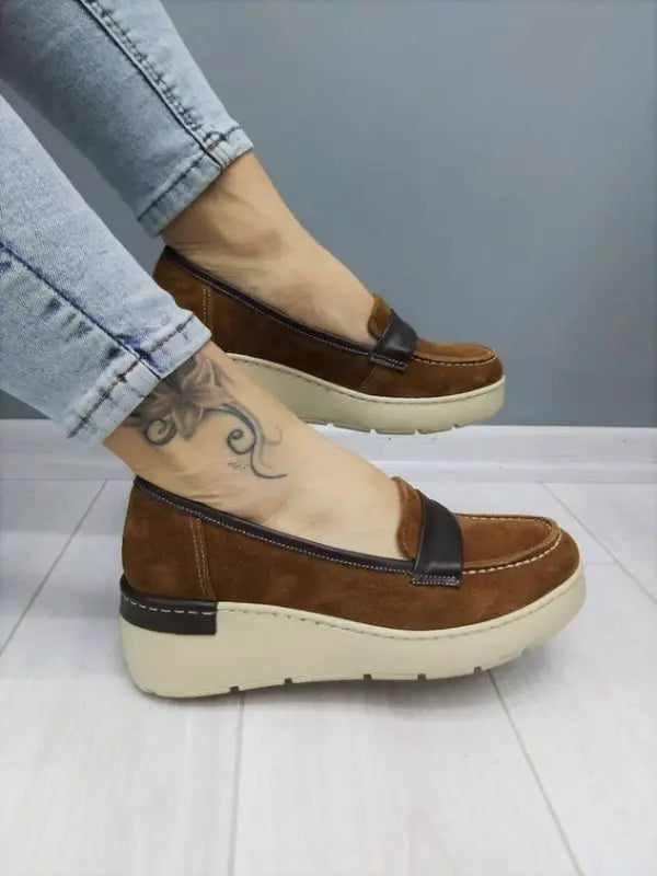 Brown leather loafer with a thick cream-colored platform sole.