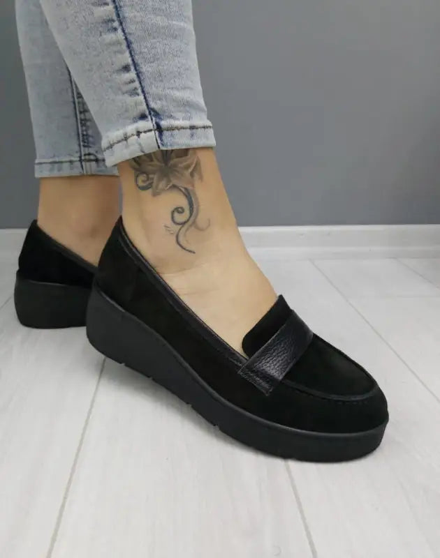 Black suede platform loafer with a wedge heel.