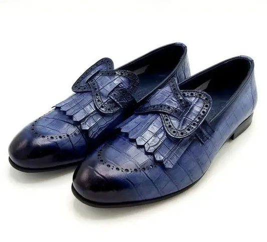 Navy blue leather loafers with decorative fringe and brogue detailing.