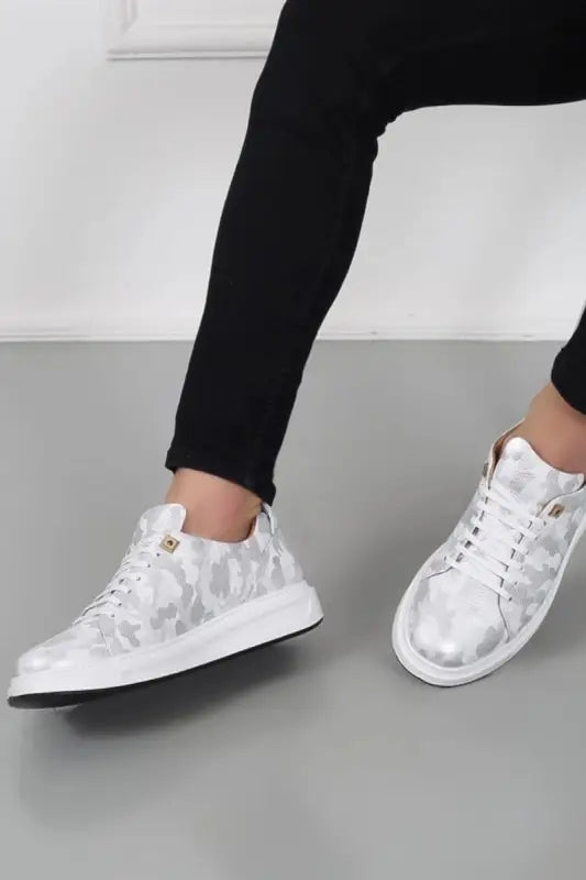 White and silver metallic camouflage pattern sneakers with laces.