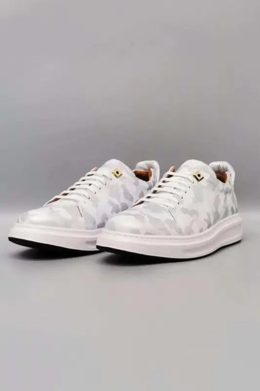 White marble-patterned sneakers with gold accents.