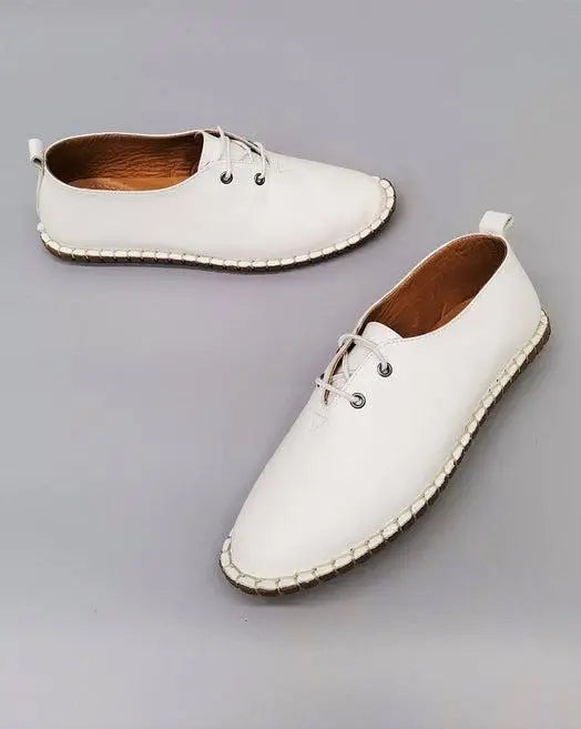 White leather lace-up espadrille shoes with stitched soles.