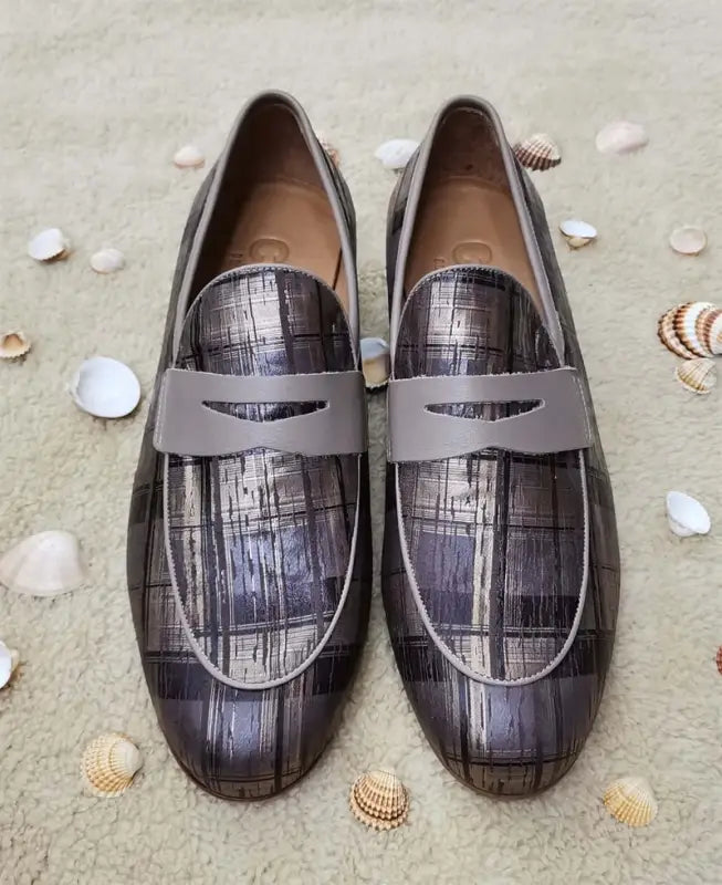 Metallic gray penny loafers with textured plaid pattern and strap detail.