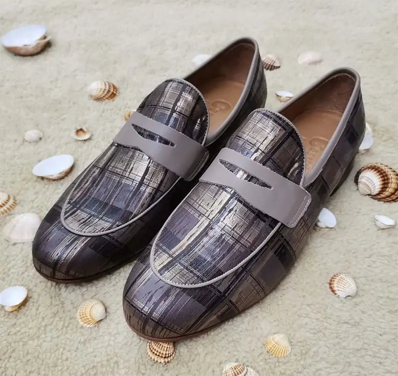 Pair of grey textured leather loafers with strap details.