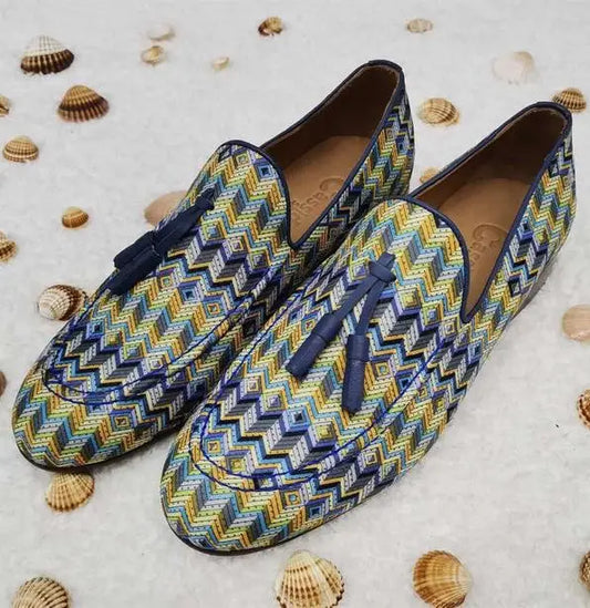 Patterned loafers with navy tassels featuring a zigzag design in blue, yellow, and white.