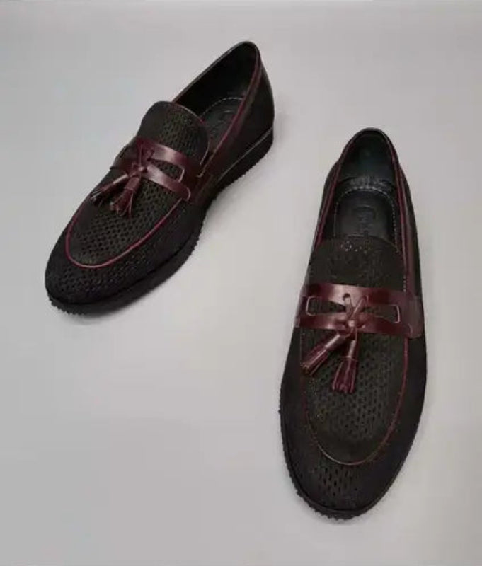 Dark brown leather loafers with burgundy tassels and perforated detailing.