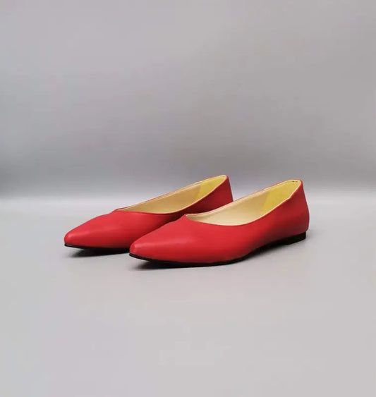 Red pointed-toe ballet flats with beige interior lining.