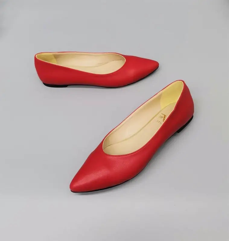 Red leather pointed-toe ballet flats.