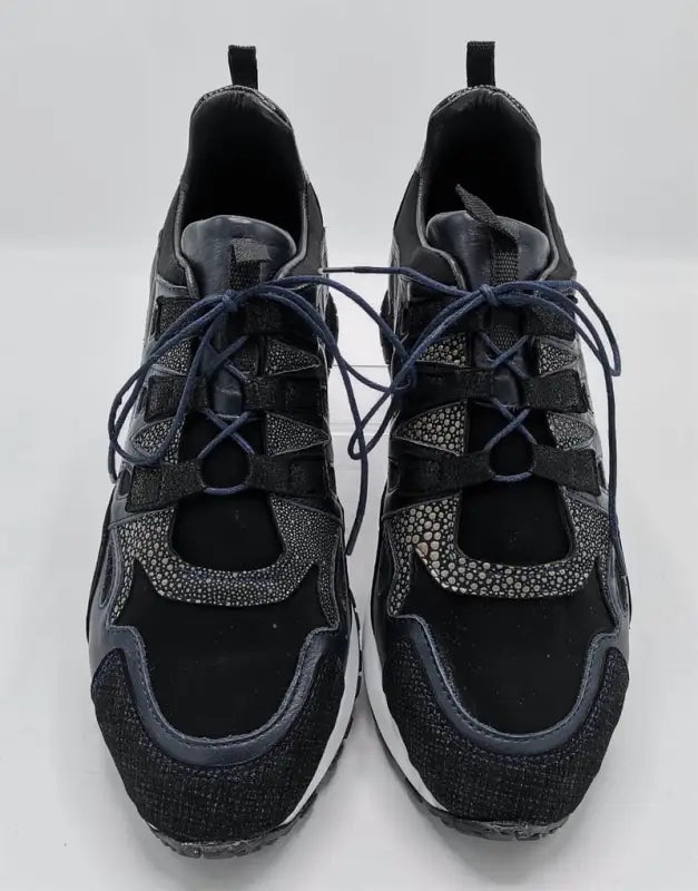 Black athletic sneakers with speckled gray accents and laces.