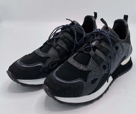 Black athletic sneakers with textured panels and white soles.