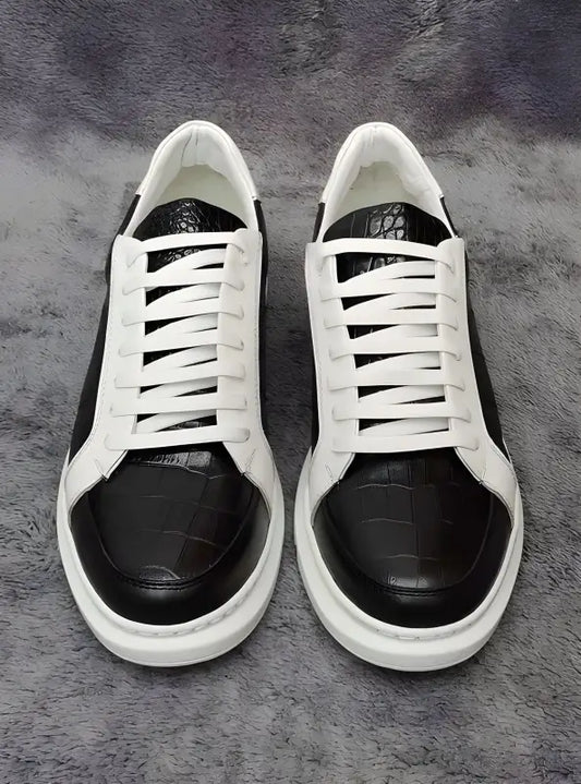 Black and white leather sneakers with white laces.