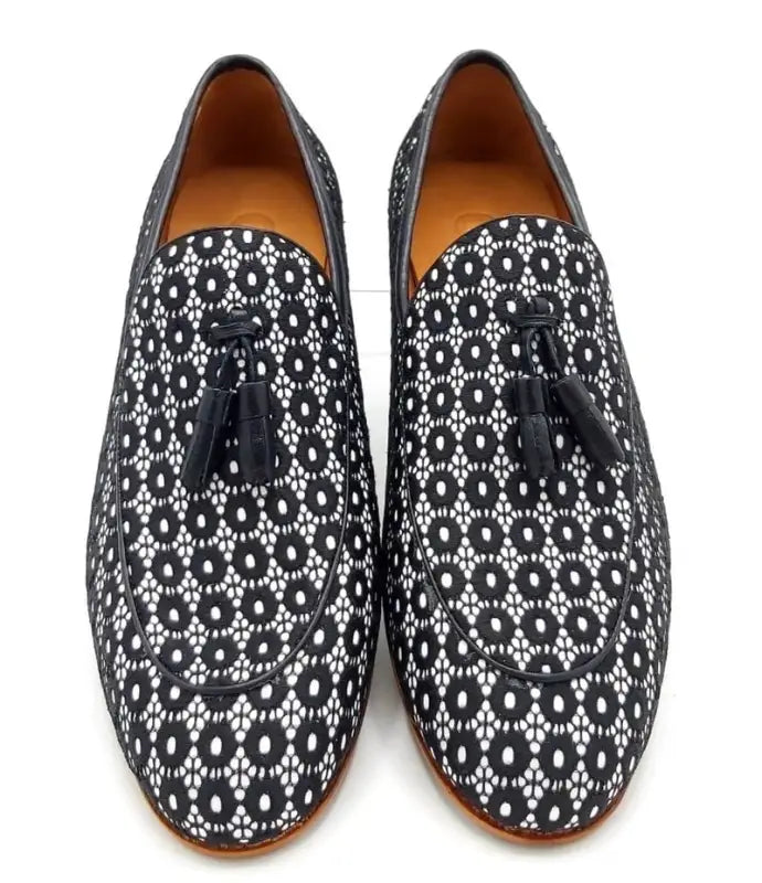 Black and white patterned loafers with tassels.