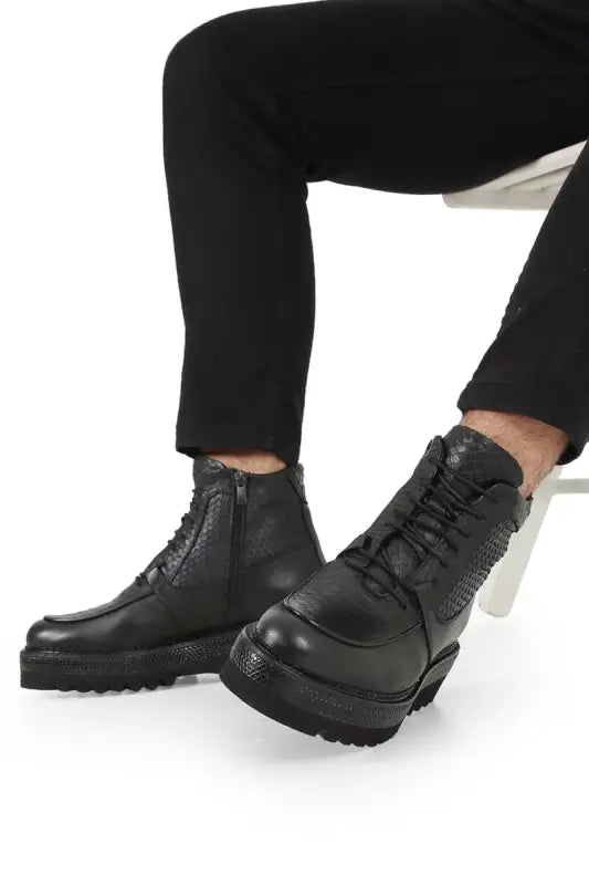 Black leather combat boots with chunky soles and lace-up design.