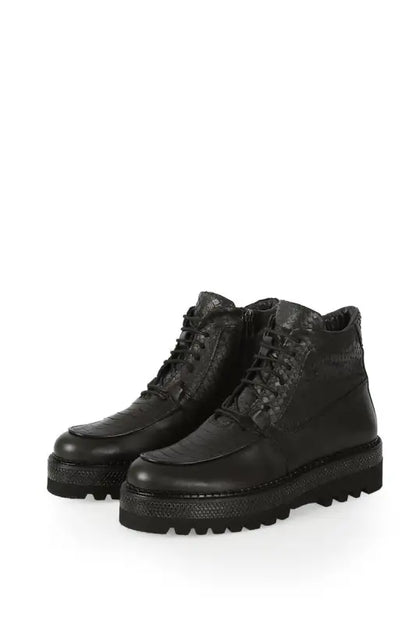 Black leather lace-up boots with chunky treaded soles.